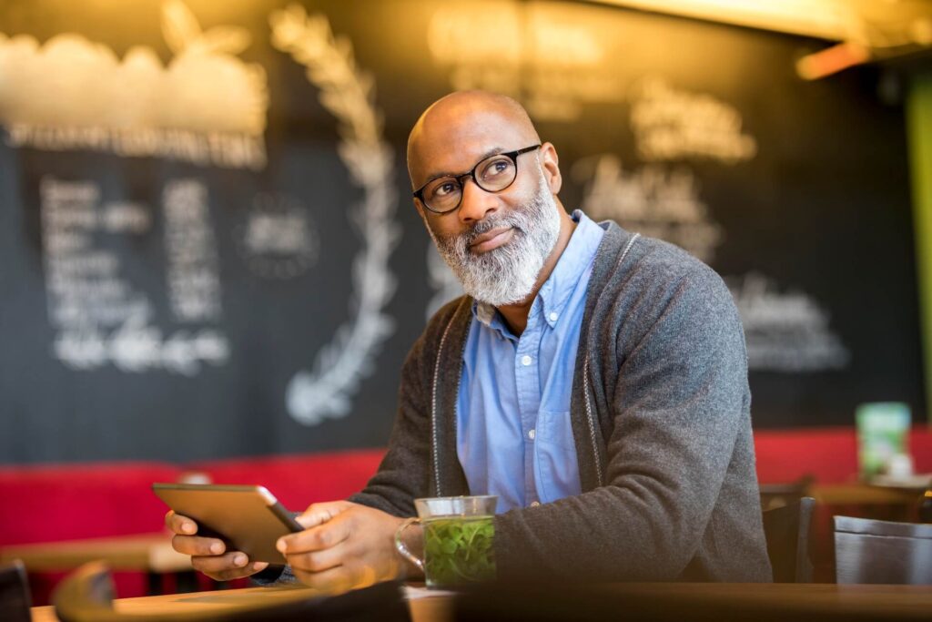 portrait-of-man-with-tablet-in-a-coffee-shop-2024-09-16-10-34-39-utc